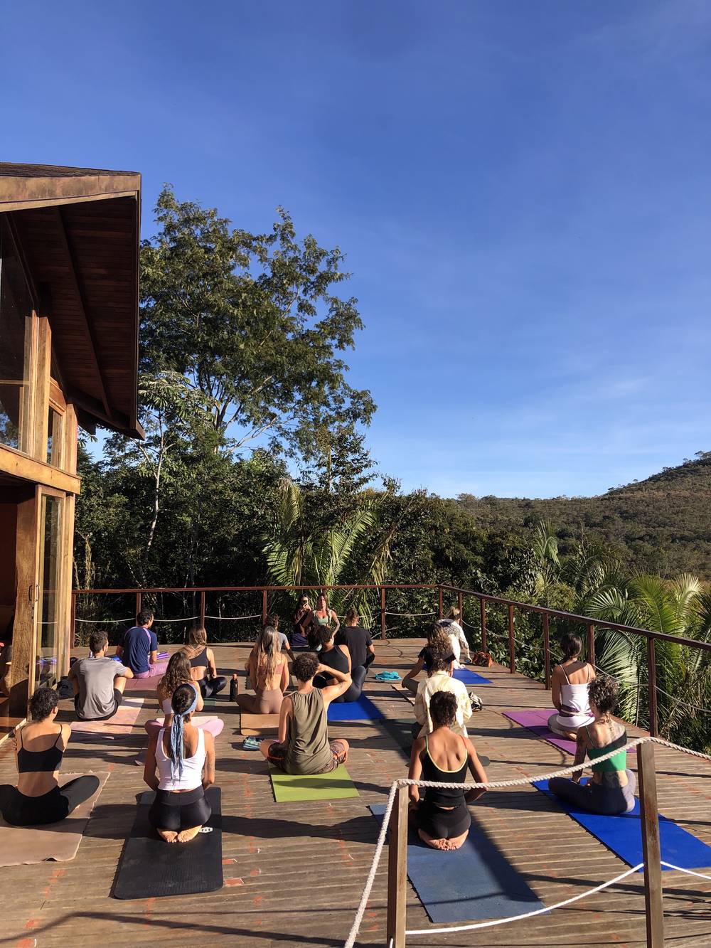 A yoga class on the open-air wooden deck