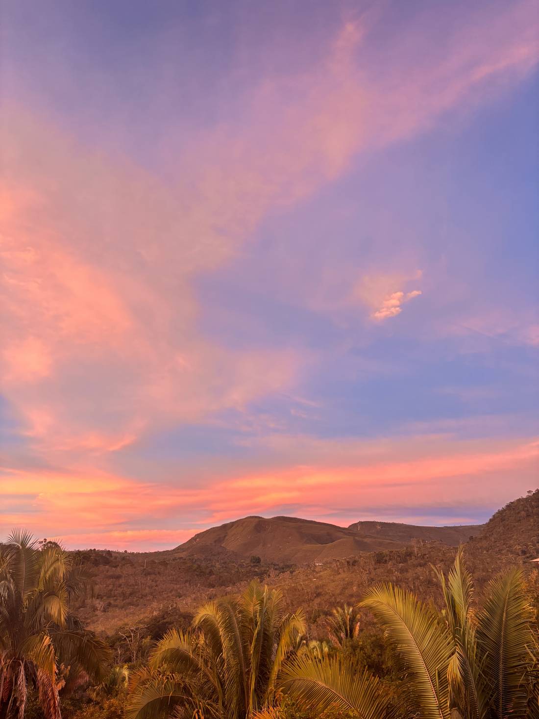Pink and orange sunset sky over the Cerrado mountains